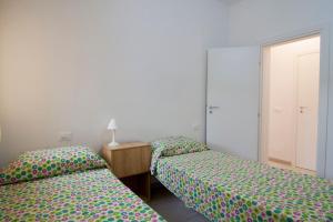 2 Betten nebeneinander in einem Zimmer in der Unterkunft Appartamento Prato in Follonica