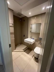 a bathroom with a toilet and a sink at Room 50Two, Itower Apartment, CBD, Gaborone in Gaborone