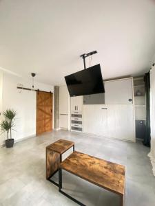 a living room with a table and a tv on the ceiling at Madrid Confort Suites in Madrid +13 photos