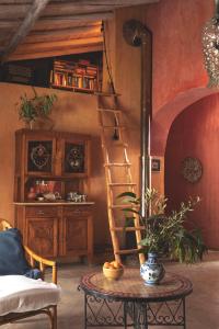 a living room with a ladder and a table at Muxima - Aljezur in Aljezur