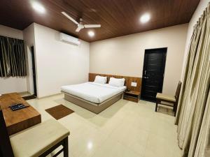 Hotel Grand Indu, 3 Star Kolhapur客房内的一张或多张床位