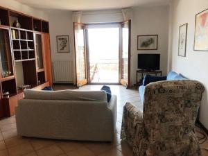 a living room with two couches and a tv at Appartamento FAB in Follonica