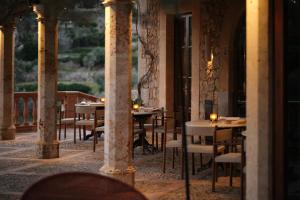Hotel Valldemossa - New Opening 2024 في فايديموسا: مطعم بطاولات وكراسي في مبنى