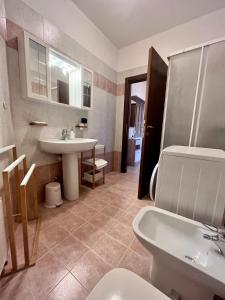 a bathroom with a sink and a toilet at Perla Apartment Verona in Verona
