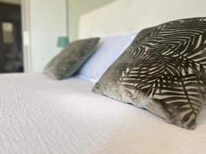 a bed with two brown pillows on it at Perla Apartment Verona in Verona