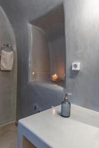 a bathroom with a counter with a candle on it at Argy's Luxury Caves - Red Cave in Megalokhori