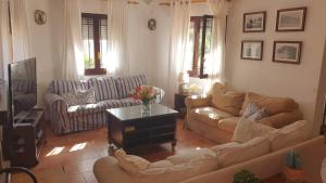 a living room with two couches and a tv at Chalet La Sopera La Manga in La Manga del Mar Menor