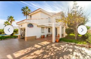 a house with two arrows on the front of it at Chalet La Sopera La Manga in La Manga del Mar Menor