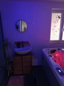 a purple bathroom with a sink and a tub at L'immortel spa 2 in Cauchy-à-la-Tour