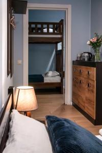 a bedroom with a bunk bed next to a dresser at Gar'is Hostel Lviv in Lviv