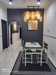 a dining room with a table and a hallway at DSR homestay in Kuantan