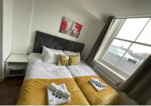 a bedroom with a bed with a large window at Webberley Stylish and Spacious Studio Unit in Stoke on Trent in Stoke on Trent