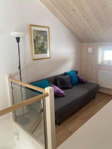 un sofá en una habitación pequeña con ventana en Tällberg, utsikt över Siljan, en Leksand