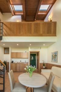 a living room with a table and a couch at Hotel Golf Inn in Lignano Sabbiadoro