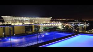 a view of a building at night with a swimming pool at 145 on Main - Legacy Green Point in Cape Town