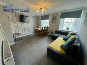 a living room with a couch and a table at Towerknowe in Hawick