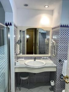 a bathroom with a sink and a mirror at Domina coral bay resort direct beach and lake 1 in Sharm El Sheikh