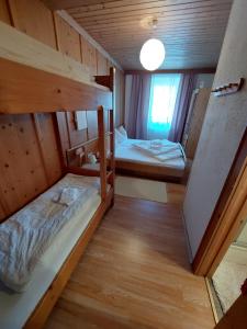 a small room with two bunk beds in it at Gasthof zur Post in Taxenbach