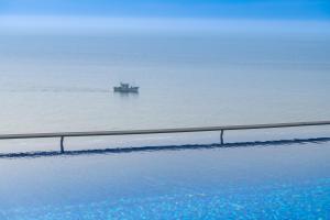 a boat in the water in the ocean at Sesimbra Oceanfront Hotel - Preferred Hotels and Resorts in Sesimbra