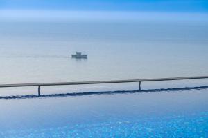 a boat in the water in the ocean at Sesimbra Oceanfront Hotel in Sesimbra