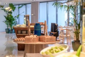 a table with baskets of eggs and bread on it at Sesimbra Oceanfront Hotel - Preferred Hotels and Resorts in Sesimbra