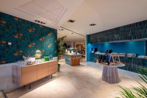 a salon with a blue wall with orange flowers at Sesimbra Oceanfront Hotel - Preferred Hotels and Resorts in Sesimbra