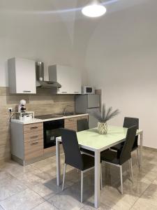 a kitchen with a table and chairs in it at Mavi house in Catania