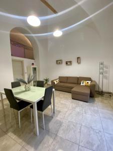 a living room with a table and a couch at Mavi house in Catania
