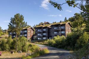 an apartment complex with a grass roof on a hill at Rauland Feriesenter in Rauland