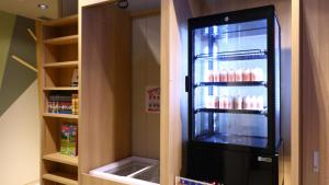 a refrigerator with drinks inside of it in a kitchen at Onyado Nono Sendai Natural Hot Spring in Sendai