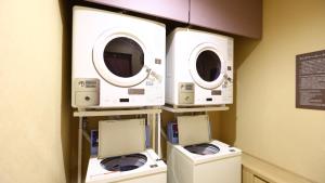 three washers and dryers on a wall in a room at Onyado Nono Sendai Natural Hot Spring in Sendai