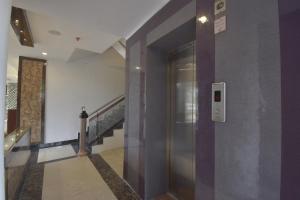 a hallway with a elevator in a building at Sidham Hotel in Jalandhar