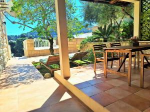 a patio with a table and chairs on a patio at Blue Promenade Apartments in Dubrovnik
