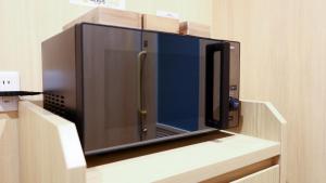 a microwave oven sitting on top of a shelf at Onyado Nono Sendai Natural Hot Spring in Sendai
