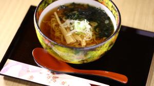 a bowl of soup sitting on a table with a spoon at Onyado Nono Sendai Natural Hot Spring in Sendai