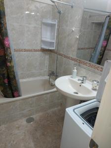 a bathroom with a sink and a toilet and a tub at SUNSET APARTMENT Las Americas in Playa Fañabe
