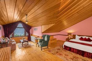a bedroom with a bed and a wooden ceiling at Mahasu House in Shimla