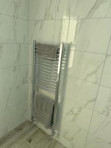 a shower with a towel rack in a bathroom at Immaculate 1-Bed Apartment in Northampton in Northampton