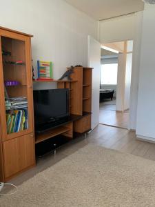 a living room with a tv and a book shelf at 2 bedroom apartment, Turku in Turku