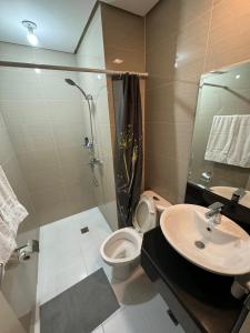 a bathroom with a shower and a toilet and a sink at 150 Newport boulevard in Manila