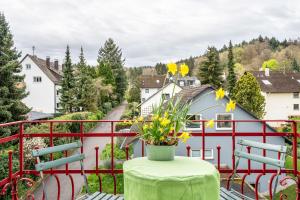 a vase of flowers on a table on a balcony at Wohnung Lichtentaler Allee in Baden-Baden