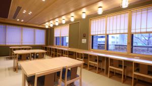 an empty classroom with tables and windows at Onyado Nono Sendai Natural Hot Spring in Sendai
