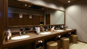 a bathroom with two sinks and a large mirror at Onyado Nono Sendai Natural Hot Spring in Sendai