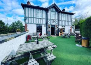 a house with a picnic table on a green lawn at The Beulah Apartments in Leeds