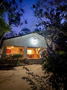 a white house with a porch and stairs at night at Waters Edge, Anuradhapura in Anuradhapura