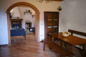 a living room with a wooden table and a fireplace at Il Frutteto Natura a Relax in Stazzema