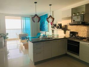 a kitchen with a sink and a counter top at Apartament Bocagrande Palmetto Beach Front 3204 in Cartagena de Indias