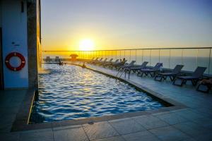 a swimming pool on a cruise ship at sunset at Apartament Bocagrande Palmetto Beach Front 3204 in Cartagena de Indias