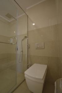 een badkamer met een toilet en een glazen douche bij Dalhousie Hotel & Resort in Dalhousie