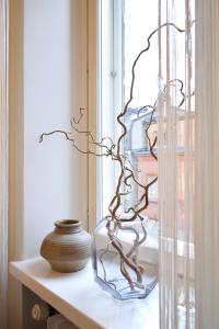 a glass vase sitting on a shelf next to a window at Studio Ateljee in Helsinki
